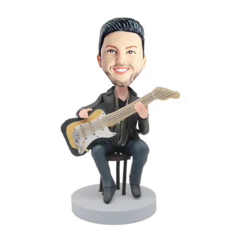 Male-Guitarist-In-Dark-Blue-T-shirt-Siting-On-A-Chair-And-Holding-A-Guitar-Custom-d1
